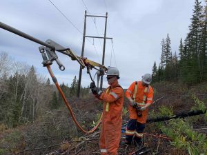 Two PowerNorth Workers at a Power Line